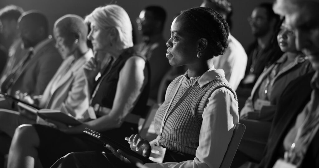 Image of Audience at Conference Representing Association Financial Strategy During Iran Conflict